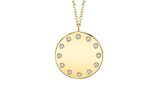 a yellow gold round pendant necklace featuring round cut diamonds