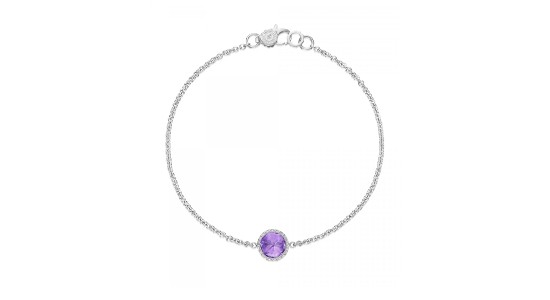 a white gold bracelet featuring a round cut amethyst