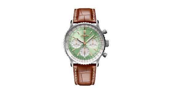 a silver watch with a mint green dial