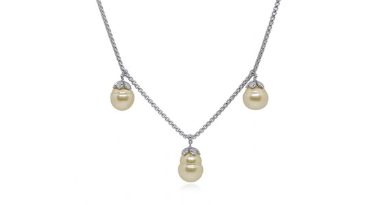 a white gold necklace with three gold hued pearls