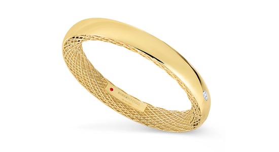 a yellow gold bangle bracelet by Roberto Coin