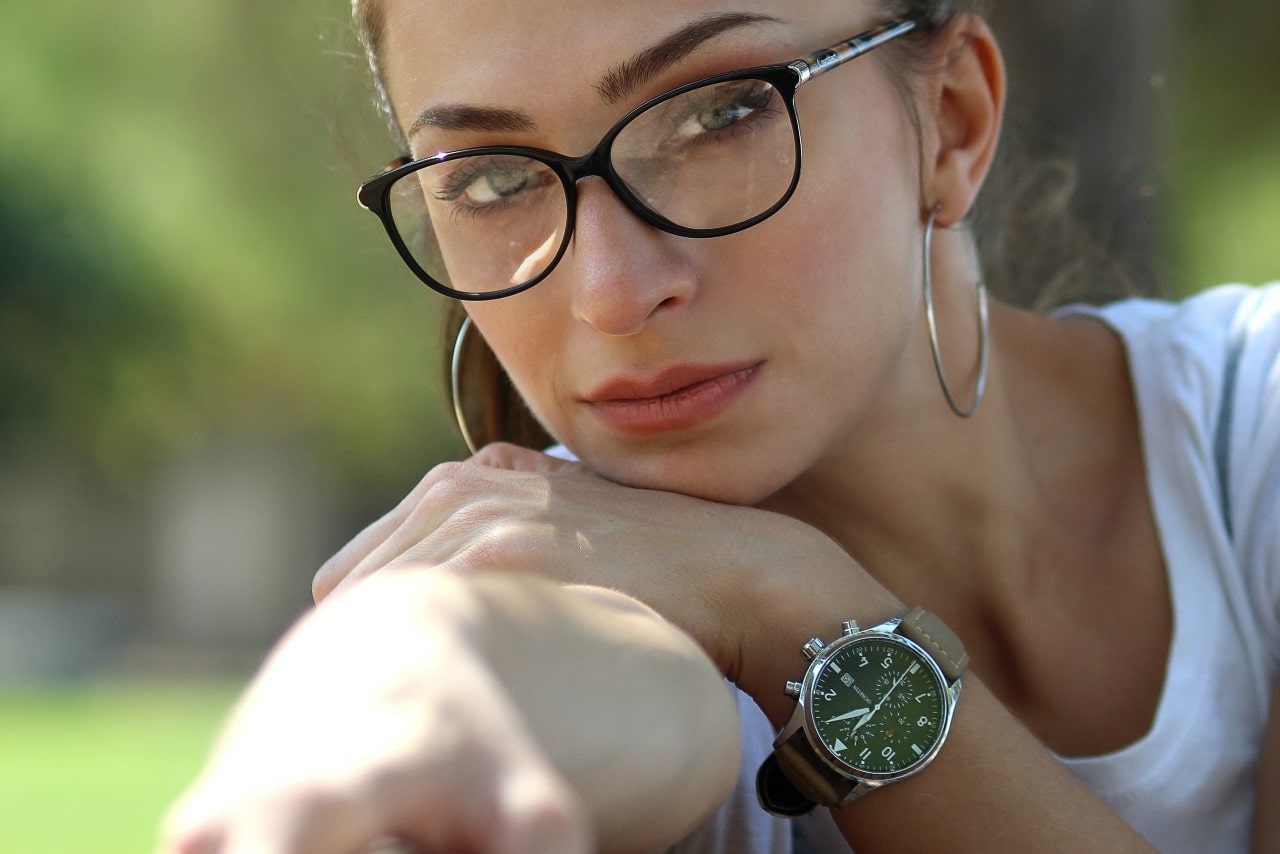 lady with glasses wearing a luxury timepiece