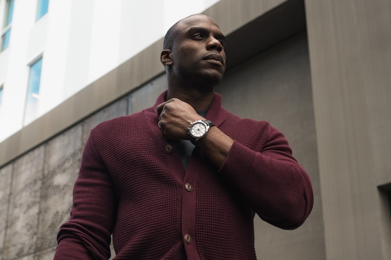man wearing a dark red sweater and luxury timepiece