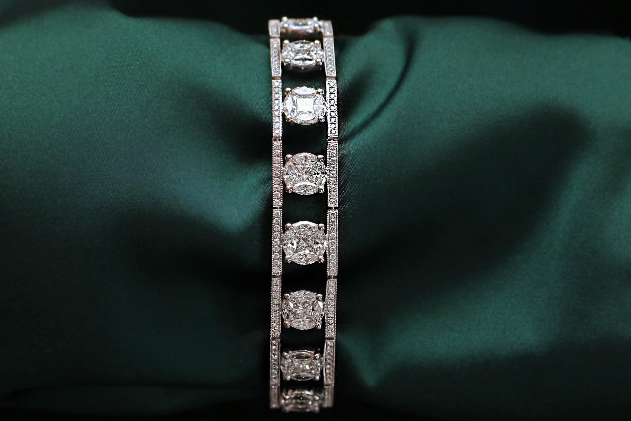 A diamond bracelet displayed on green silk