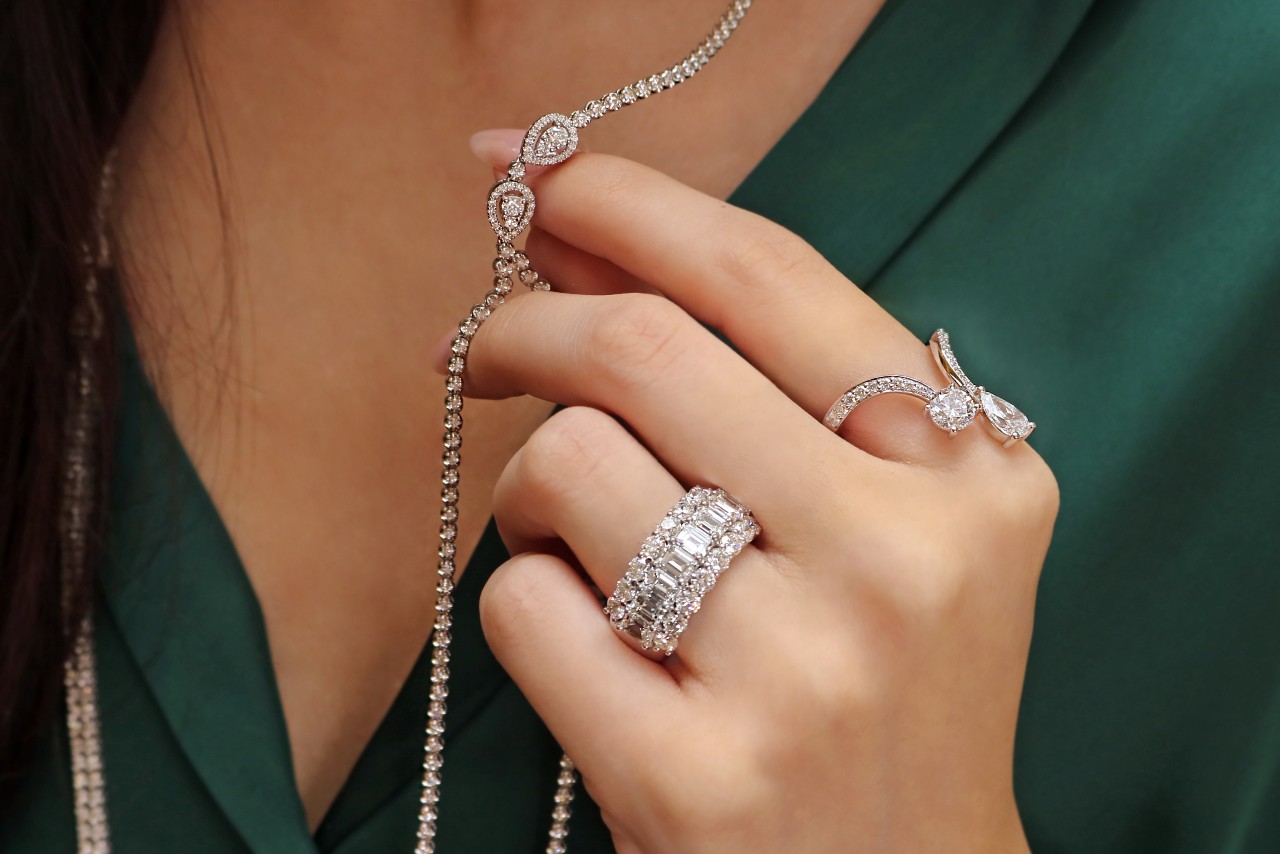 A woman wearing a beautiful diamond necklace and rings