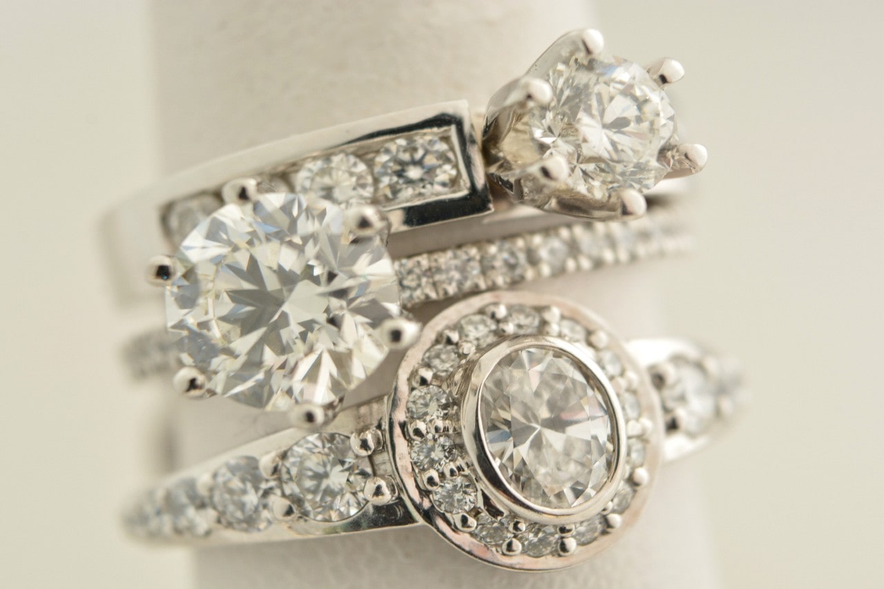 three engagement rings in various styles